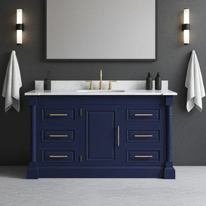 Bathroom vanity with blue cabinet, white countertop, and gold fixtures against a gray wall.