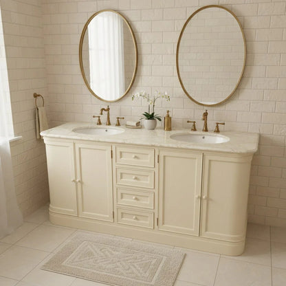 Bathroom vanity with two round mirrors, marble countertop, and tiled walls.