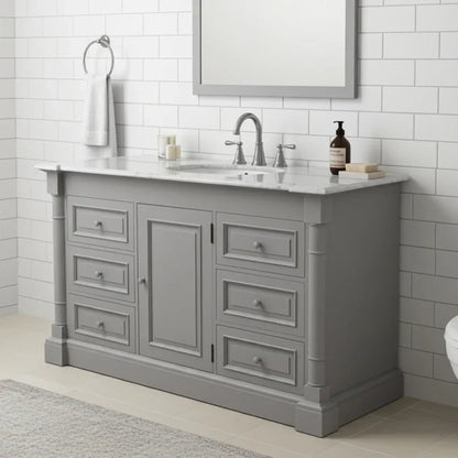 Gray bathroom vanity with white countertop, sink, and faucet in a tiled bathroom.