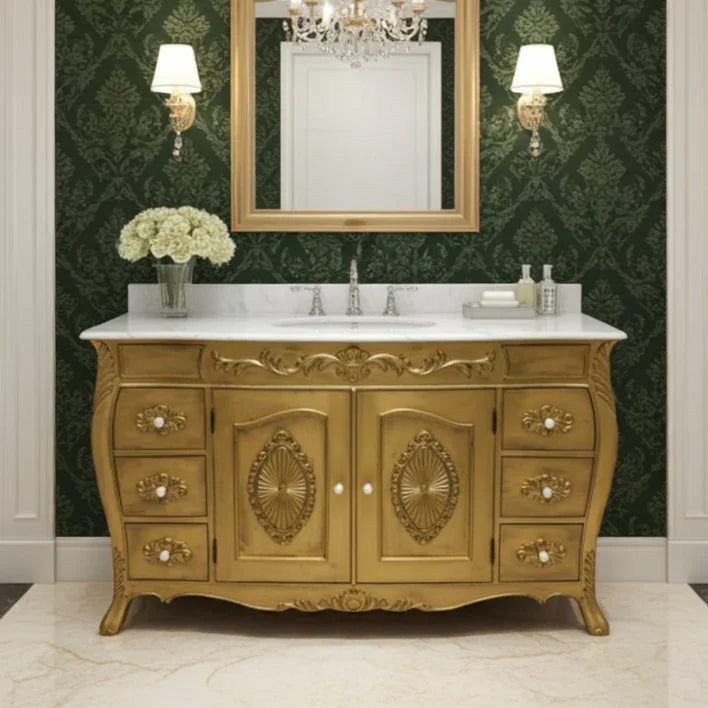 Decorative gold bathroom vanity with marble countertop, mirror, and wall lights against a green patterned wallpaper.