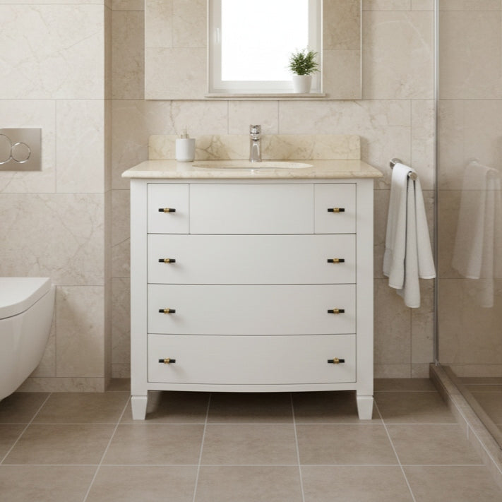 Bathroom vanity with marble countertop and sink in a tiled bathroom.