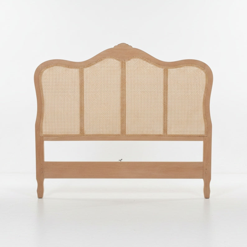 A light natural wood bed frame headboard with a curved top and woven cane panels, shown against a plain white studio background.