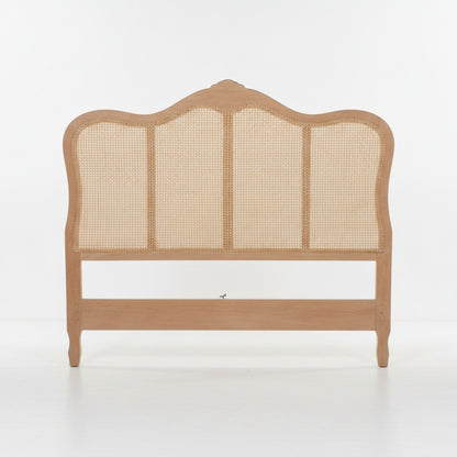 A light natural wood bed frame headboard with a curved top and woven cane panels, shown against a plain white studio background.