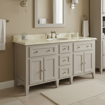 Bathroom vanity with marble countertop and mirror in a neutral-toned bathroom.