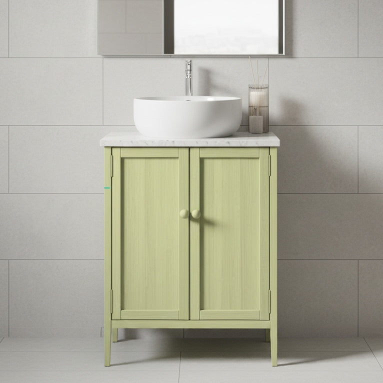 Green vanity unit with white sink against a tiled bathroom wall