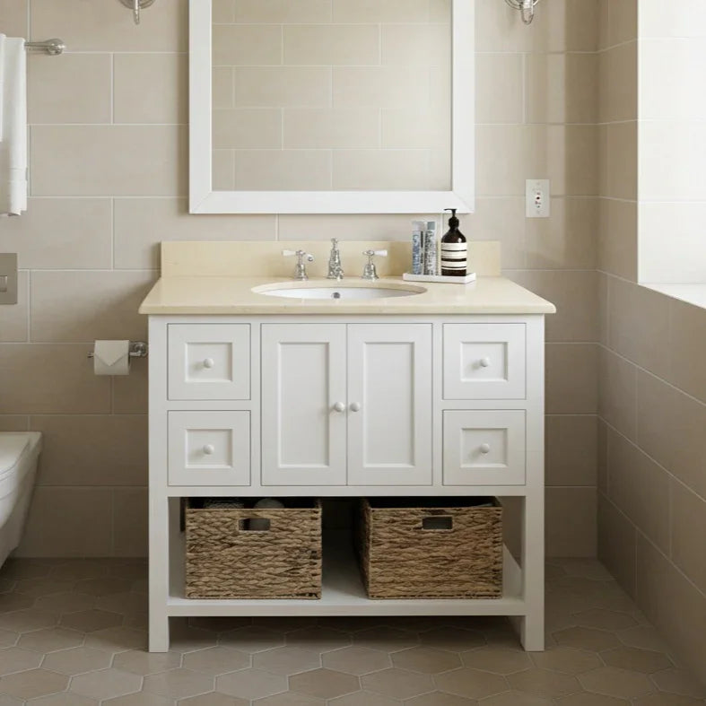 Bathroom vanity with sink, cabinets, and decorative elements in a tiled bathroom.