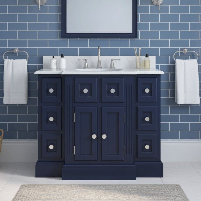 blue single sink vanity unit with marble counter top in matching style bathroom