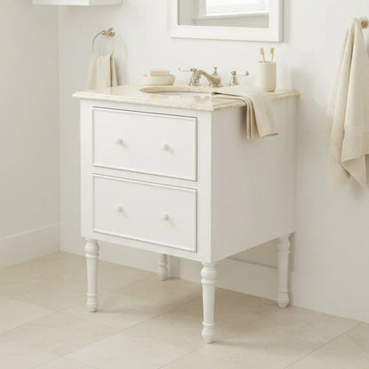 White bathroom vanity with marble countertop and sink in a bright room.
