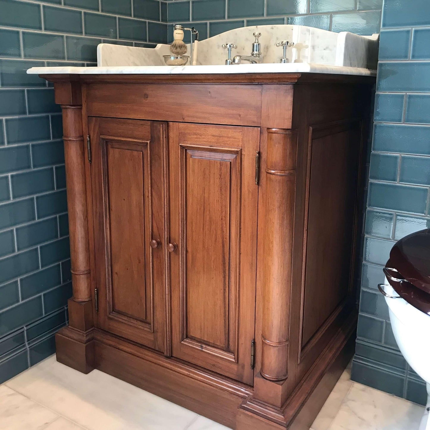 natural wood, polished finish, single sink vanity unit with marble top in blue bathroom