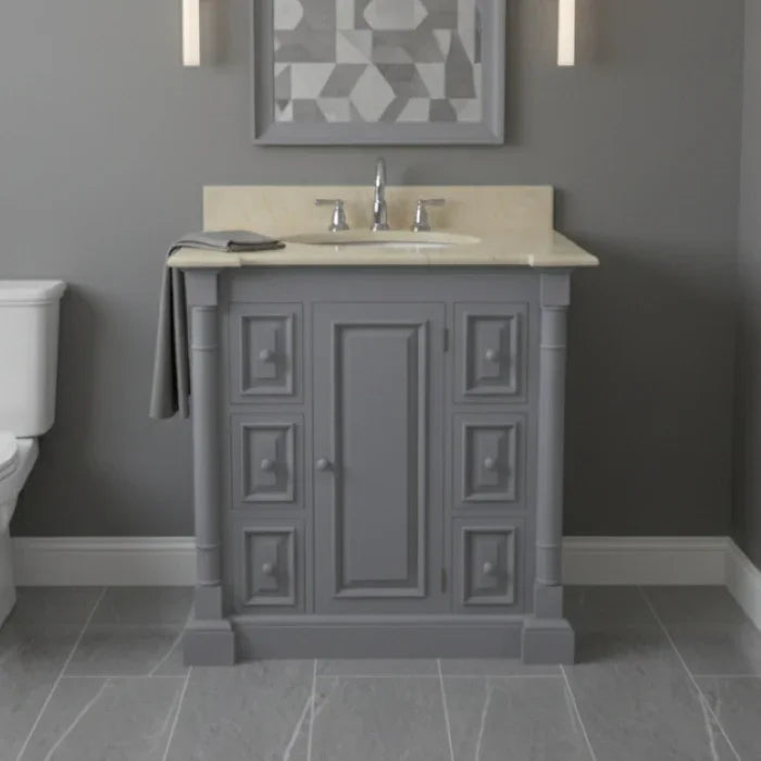 Bathroom vanity with marble countertop and sink against a gray wall.