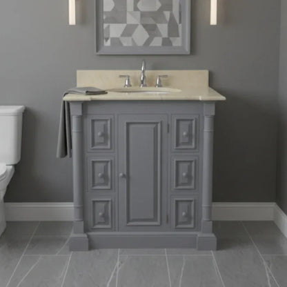 Bathroom vanity with marble countertop and sink against a gray wall.