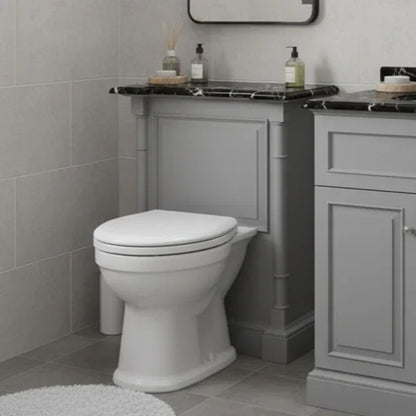 Bathroom with a white toilet and gray vanity unit.