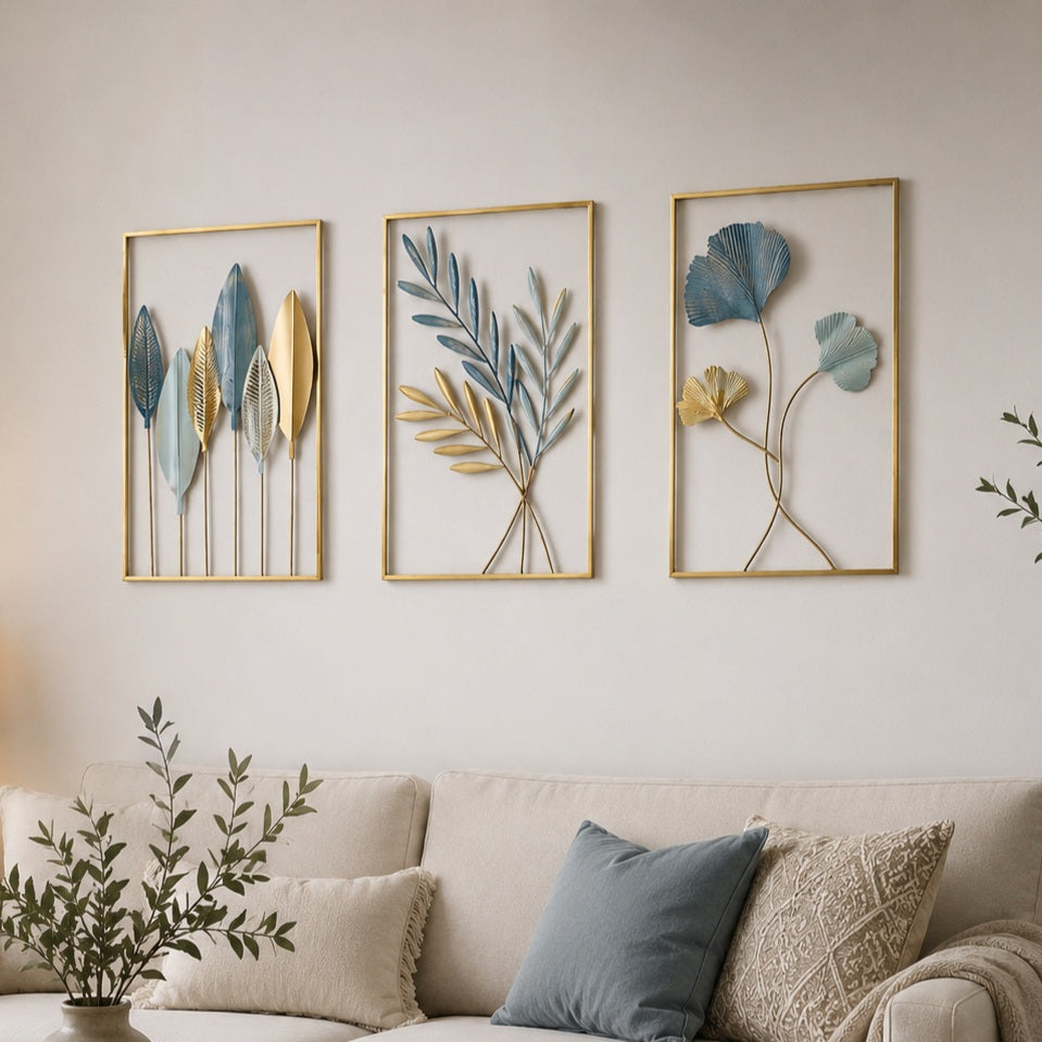 Three framed botanical wall art pieces above a sofa with decorative pillows.