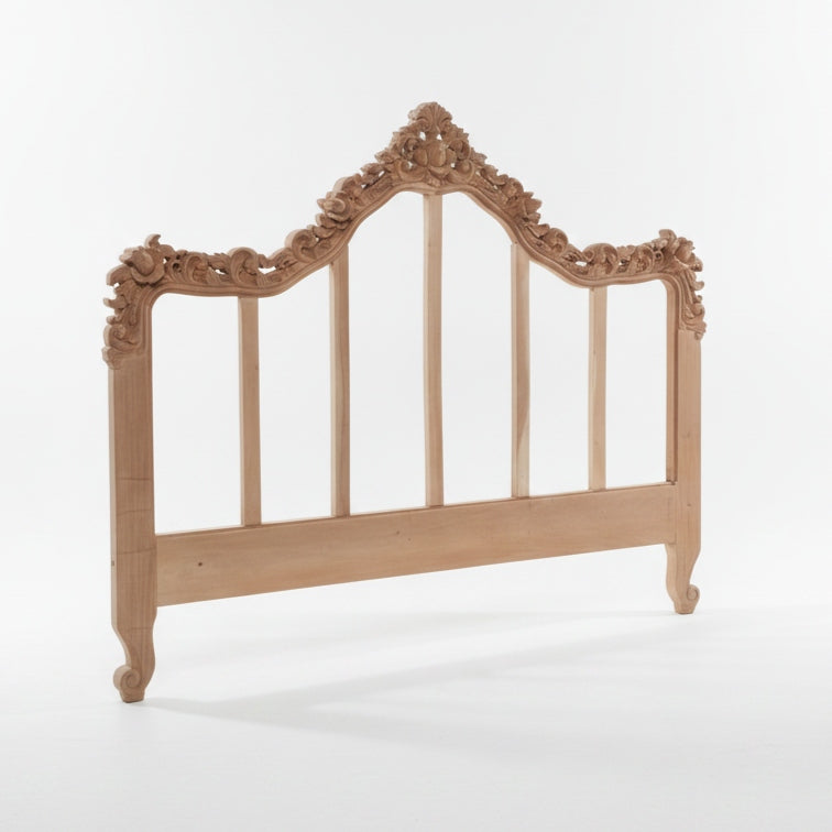 An ornate light natural wood headboard with carved floral details and vertical slats, shown on a clean white studio background.