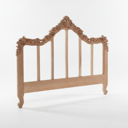An ornate light natural wood headboard with carved floral details and vertical slats, shown on a clean white studio background.