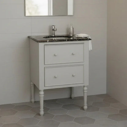 Bathroom vanity with sink against a tiled wall