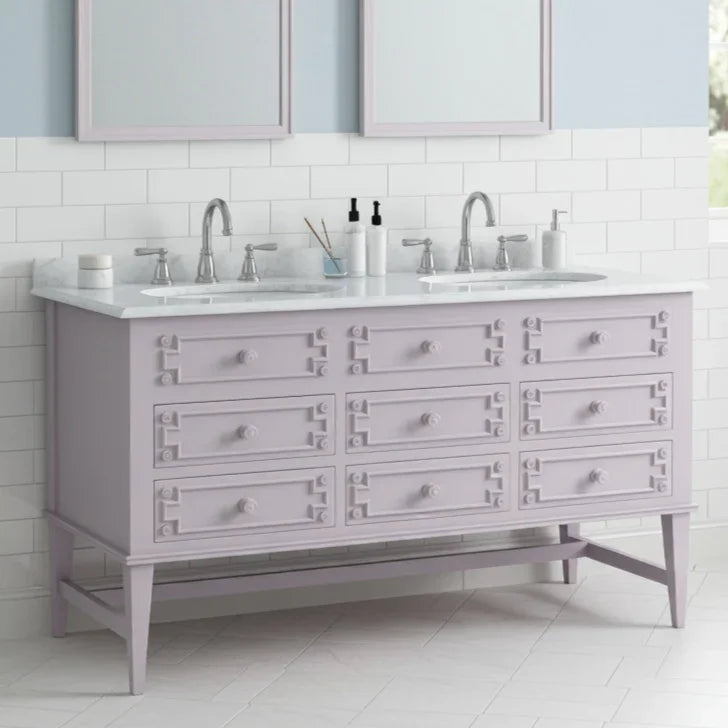 Bathroom vanity with double sink and light gray cabinets.