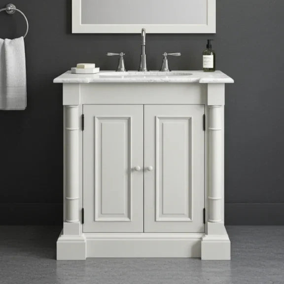 White bathroom vanity with marble countertop and sink against a dark gray wall.