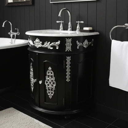Black bathroom vanity with ornate silver designs in a darkly paneled room.